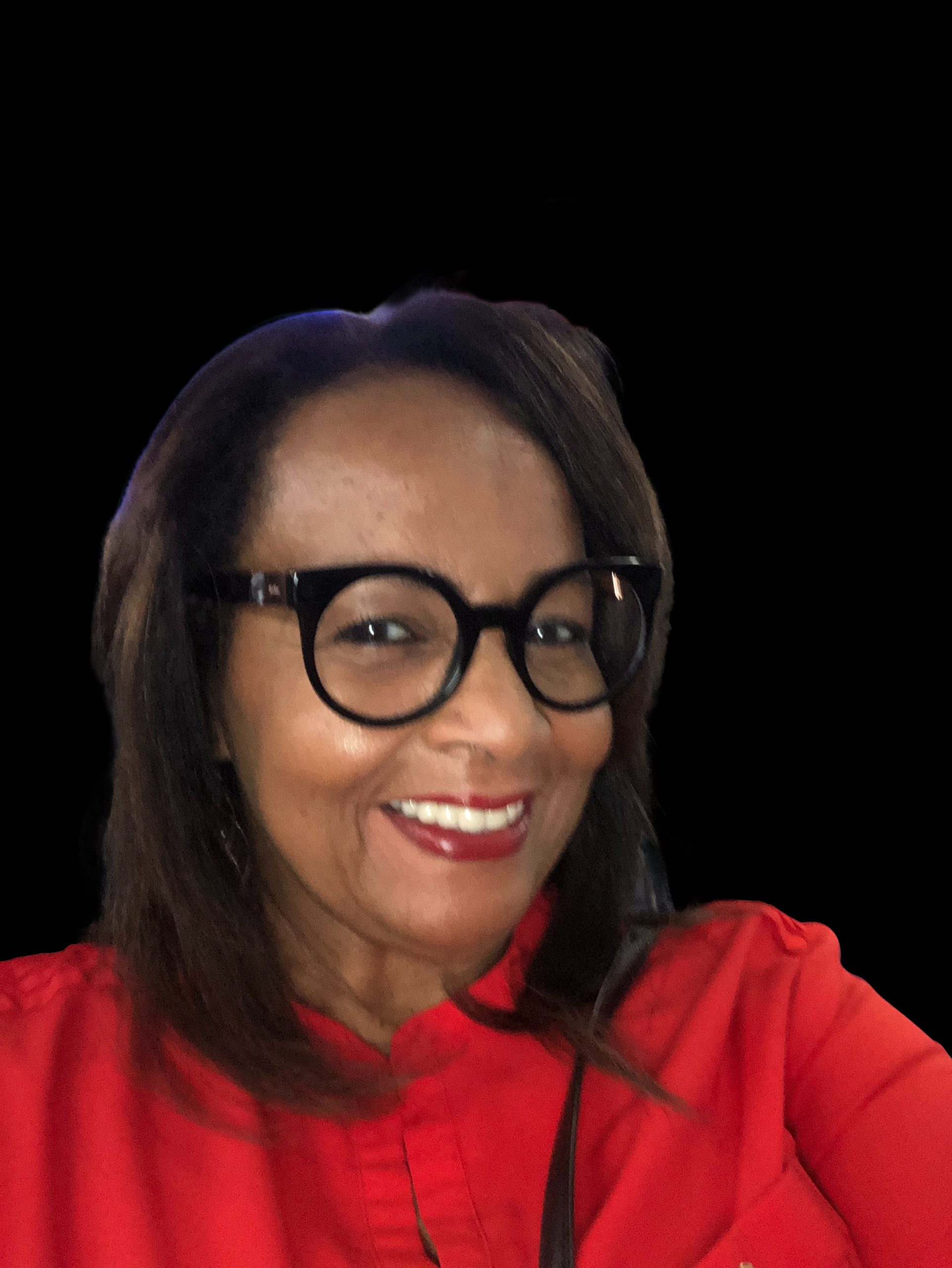 Shelia Dudley smiling with black round glasses and a red shirt